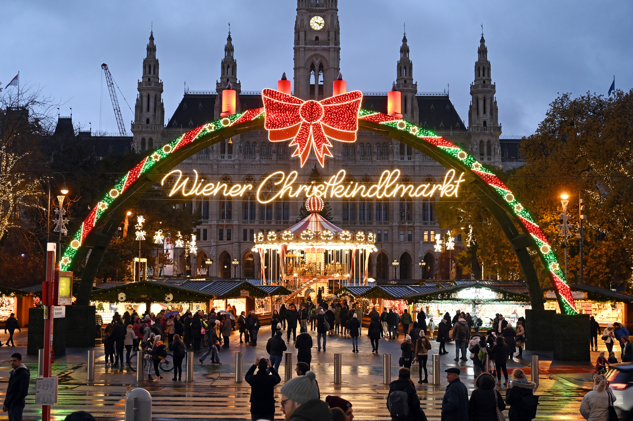 View of the illuminated Christmas market in front of the City Hall in Vienna, Austria, in the evening