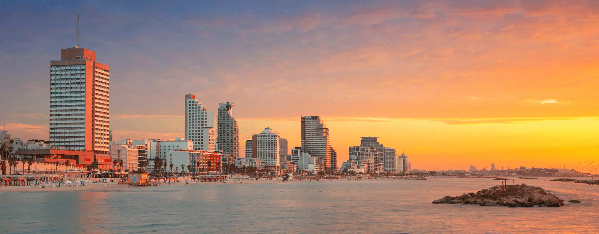 Sunset on the beach in Tel Aviv, Israel – a beautiful seaside vacation destination in a modern city.