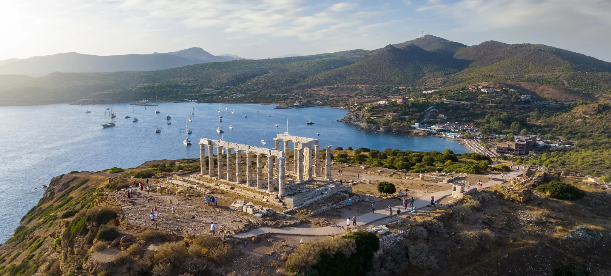 Aerial view of Cape Sounion beach and the historic Temple of Poseidon near Athens, Greece.