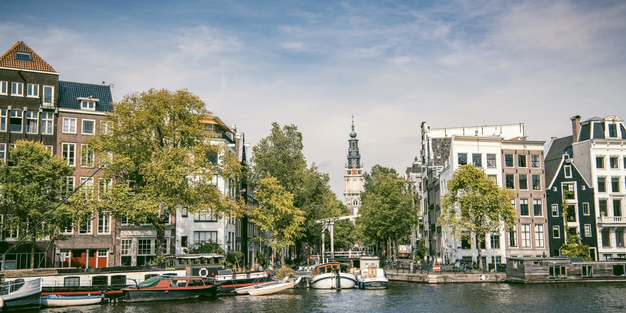 Summer view over Amstel River in Amsterdam’s downtown canal district – a scenic destination in the Netherlands